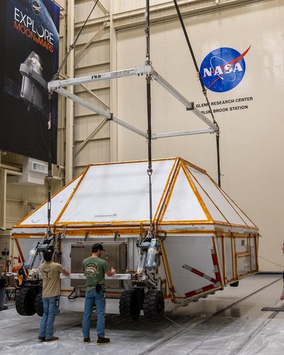 The Crated Orion I Crew Module is lowered in the Space Experimen
