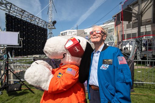 Administrator Bill Nelson and Snoopy view the eclipse