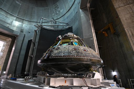 The Orion crew module is transported through the vacuum chamber