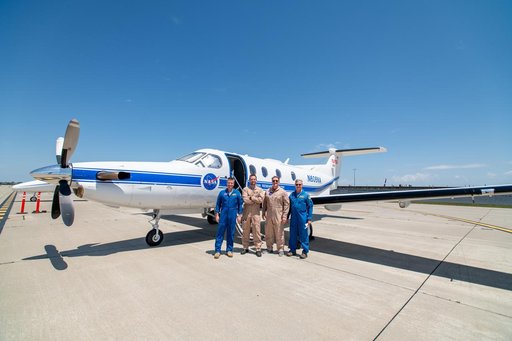 Laser Comm Team Poses In Front Of PC-12 Aircraft