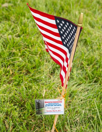 Members of the Veterans Advisory Committee place flags on the Go