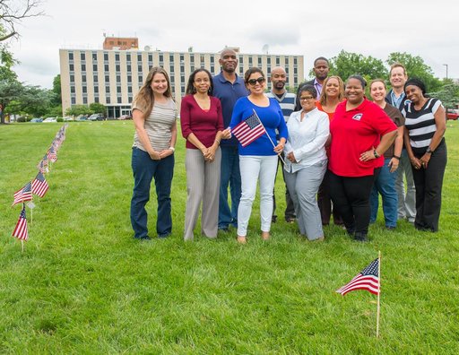 Members of the Veterans Advisory Committee place flags on the Go
