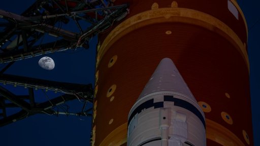 Moon Seen Shining on Full Artemis II Stack at Launch Pad 39B