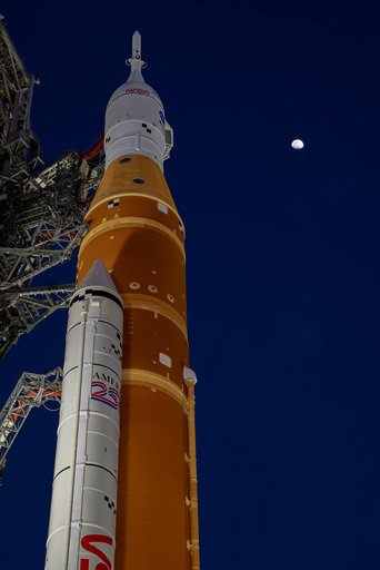 Moon Seen Shining on Full Artemis II Stack at Launch Pad 39B