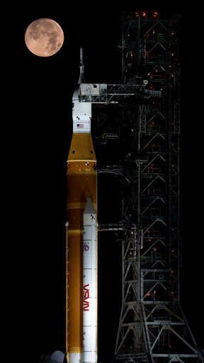 Full Moon Setting Behind Full Artemis II Stack at Launch Pad 39B