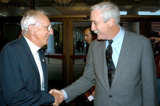 KENNEDY SPACE CENTER, FLA. - Gunther Wendt (left), NASA retiree, shakes hands with NASA Administrator Sean O'Keefe during the annual Congressional Dinner hosted by the Florida Space Business Roundtable.  The dinner kicked off the annual Space Congress, held April 28-May 1, 2003, in Cape Canaveral, F