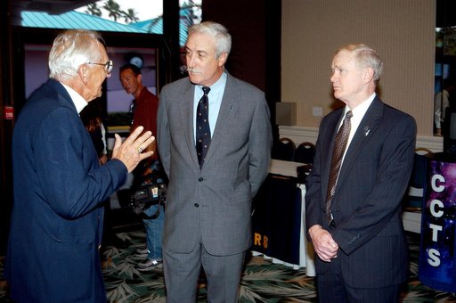 KENNEDY SPACE CENTER, FLA. - Gunther Wendt (left), NASA retiree, holds the attention of NASA Administrator Sean O'Keefe (center) and Center Director Roy Bridges Jr. (right) at the annual Congressional Dinner hosted by the Florida Space Business Roundtable.  The dinner kicked off the annual Space Con
