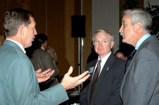 KENNEDY SPACE CENTER, FLA. - Mike McCulley (left), chief operating officer with United Space Alliance, talks with Center Director Roy Bridges Jr. (center) and NASA Administrator Sean O'Keefe (right) during the annual Congressional Dinner hosted by the Florida Space Business Roundtable.   The dinner 