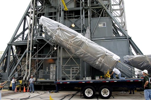 KENNEDY SPACE CENTER, FLA. - At Launch Complex 17-A, Cape Canaveral Air Force Station, the first half of the fairing for the Mars Exploration Rover 2 (MER-2/MER-A) is lifted off the transporter.  The fairing will be installed around the payload for protection during launch.  The MER Mission consists