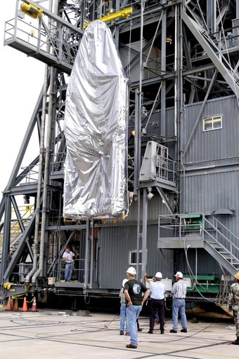 KENNEDY SPACE CENTER, FLA. -  At Launch Complex 17-A, Cape Canaveral Air Force Station, the first half of the fairing for the Mars Exploration Rover 2 (MER-2/MER-A) is lifted up the launch tower.  The fairing will be installed around the payload for protection during launch.  The MER Mission consist
