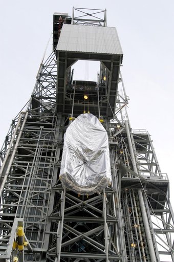KENNEDY SPACE CENTER, FLA. -  At Launch Complex 17-A, Cape Canaveral Air Force Station, the first half of the fairing for the Mars Exploration Rover 2 (MER-2/MER-A) is lifted up the launch tower.  The fairing will be installed around the payload for protection during launch.  The MER Mission consist