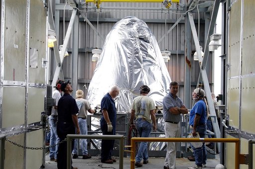 KENNEDY SPACE CENTER, FLA. - At Launch Complex 17-A, Cape Canaveral Air Force Station, the first half of the fairing for the Mars Exploration Rover 2 (MER-2/MER-A) reaches the top of the launch tower.  The fairing will be installed around the payload for protection during launch.  The MER Mission co