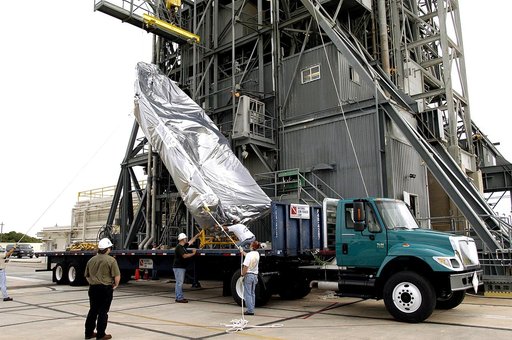 KENNEDY SPACE CENTER, FLA. - After arriving at Launch Complex 17-A, Cape Canaveral Air Force Station, the second half of the fairing for the Mars Exploration Rover 2 (MER-2/MER-A) is lifted off its transporter.  The fairing will be installed around the payload for protection during launch.  The MER 