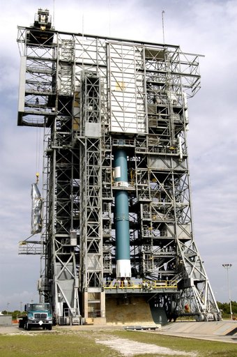 KENNEDY SPACE CENTER, FLA. - At Launch Complex 17-A, Cape Canaveral Air Force Station, the second half of the fairing for the Mars Exploration Rover 2 (MER-2/MER-A) is lifted up the outside of the launch tower.  Visible on another side is the Delta II rocket that will carry the payload into space.  