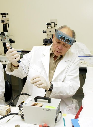 KENNEDY SPACE CENTER, FLA. -  Dr. Dennis Morrison, NASA Johnson Space Center, processes one of the experiments carried on mission STS-107. Several experiments were found during the search for Columbia debris. Included in the Commercial ITA Biomedical Experiments payload on mission STS-107 are urokin