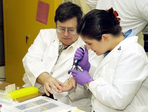 KENNEDY SPACE CENTER, FLA. -  From left, Barry Perlman, Pembroke Pines Charter Middle School in Florida, and Valerie Cassanto, Instrumentation Technology Associates, Inc., process one of the experiments carried on mission STS-107. Several experiments were found during the search for Columbia debris.