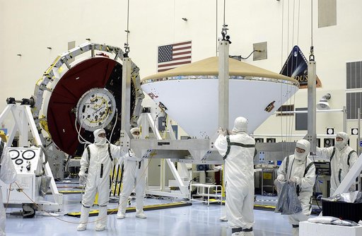 KENNEDY SPACE CENTER, FLA. - An overhead crane moves the Mars Exploration Rover 2 (MER-2) entry vehicle across the Payload Hazardous Servicing Facility toward a spin table for a dry-spin test.  The MER Mission consists of two identical rovers designed to cover roughly 110 yards each Martian day over