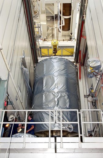KENNEDY SPACE CENTER, FLA. - On Launch Complex 17-B, Cape Canaveral Air Force Station, the Space Infrared Telescope Facility (SIRTF) observatory is moved toward the outside of the launch tower.  It will be lowered and taken back to NASA Spacecraft Hangar AE. SIRTF will remain in the clean room at Ha