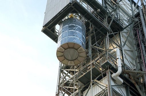 KENNEDY SPACE CENTER, FLA. - On Launch Complex 17-B, Cape Canaveral Air Force Station, the Space Infrared Telescope Facility (SIRTF) observatory is lowered to the ground and taken back to NASA Spacecraft Hangar AE. SIRTF will remain in the clean room at Hangar AE until it returns to the pad in early