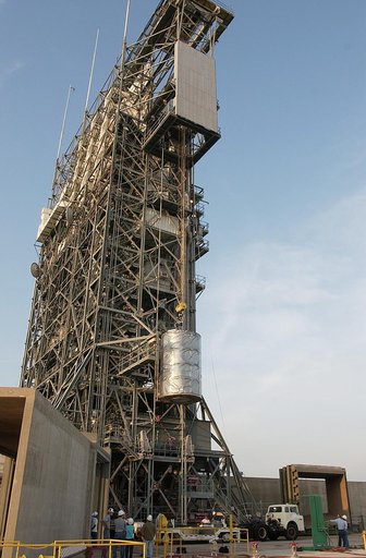 KENNEDY SPACE CENTER, FLA. - On Launch Complex 17-B, Cape Canaveral Air Force Station, the Space Infrared Telescope Facility (SIRTF) observatory is lowered to the ground and taken back to NASA Spacecraft Hangar AE. SIRTF will remain in the clean room at Hangar AE until it returns to the pad in early