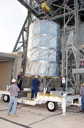 KENNEDY SPACE CENTER, FLA. - On Launch Complex 17-B, Cape Canaveral Air Force Station, the Space Infrared Telescope Facility (SIRTF) observatory is lowered onto a transporter to be taken back to NASA Spacecraft Hangar AE. SIRTF will remain in the clean room at Hangar AE until it returns to the pad i