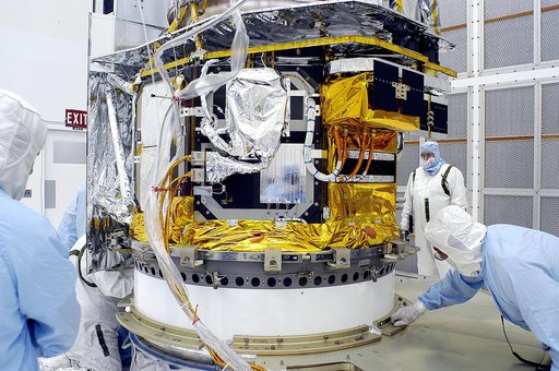 KENNEDY SPACE CENTER, FLA. -  In the NASA Spacecraft Hangar AE, the Space Infrared Telescope Facility (SIRTF), which has been returned to the hangar from the launch pad, is uncovered by workers following its arrival.   SIRTF will remain in the clean room until it returns to the pad in early August. 