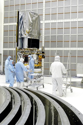 KENNEDY SPACE CENTER, FLA. -  Workers in NASA Spacecraft Hangar AE prepare to begin further processing of the Space Infrared Telescope Facility (SIRTF), which has been returned to the hangar from the launch pad. Sections of the transportation canister used in the move are in the foreground.  SIRTF w