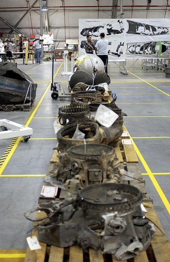 KENNEDY SPACE CENTER, FLA. - Large items of Columbia debris fill a long table in the RLV Hangar.  The items shipped to KSC number more than 82,000 and weigh 84,800 pounds or 38 percent of the total dry weight of Columbia.  Of those items, 78,760 have been identified, with 753 placed on the left wing