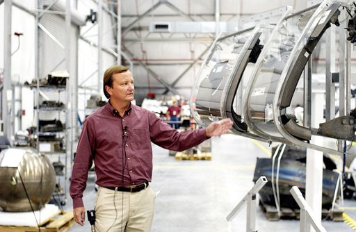 KENNEDY SPACE CENTER, FLA. - While talking to the media in the RLV Hangar, Shuttle Launch Director Mike Leinbach points to the model of the leading edge of an orbiter’s left wing that is being used to reconstruct Columbia’s wing with the recovered debris.  The items shipped to KSC number more than 8