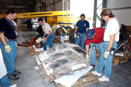 KENNEDY SPACE CENTER, FLA. -  Members of the Columbia Reconstruction Project Team work with pieces of debris in the RLV Hangar. The items shipped to KSC number more than 82,000 and weigh 84,800 pounds or 38 percent of the total dry weight of Columbia. Of those items, 78,760 have been identified, wit
