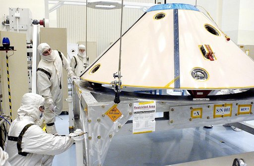 KENNEDY SPACE CENTER, FLA. - Workers in the Payload Hazardous Servicing Facility prepare to lift and move the backshell, a protective cover for the Mars Exploration Rover 1 (MER-1) and its lander.  NASA's twin Mars Exploration Rovers are designed to study the history of water on Mars. These robotic 