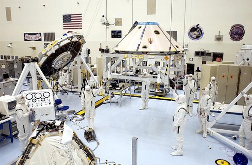 The backshell for the Mars Exploration Rover 1 (MER-1) is moved toward the rover (foreground, left).  The backshell is a protective cover for the rover.  NASA's twin Mars Exploration Rovers are designed to study the history of water on Mars. These robotic geologists are equipped with a robotic arm, 