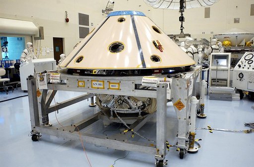 KENNEDY SPACE CENTER, FLA. - The backshell is in place over the Mars Exploration Rover 1 (MER-1).  The backshell is a protective cover for the rover.  NASA's twin Mars Exploration Rovers are designed to study the history of water on Mars. These robotic geologists are equipped with a robotic arm, a d