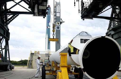 KENNEDY SPACE CENTER, FLA. -  On Launch Complex 17-A, Cape Canaveral Air Force Station, a solid rocket booster is prepared to raise it to vertical and lift up the launch tower.  It is one of nine that will be mated to the Delta rocket (in the background) to launch Mars Exploration Rover 2. NASA’s tw