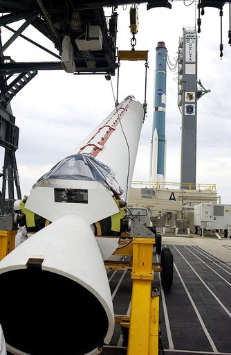 KENNEDY SPACE CENTER, FLA. - On Launch Complex 17-A, Cape Canaveral Air Force Station, a solid rocket booster is raised off the transporter.  When vertical, it will be lifted up the launch tower and mated to the Delta rocket (in the background) to launch Mars Exploration Rover 2. NASA’s twin Mars Ex