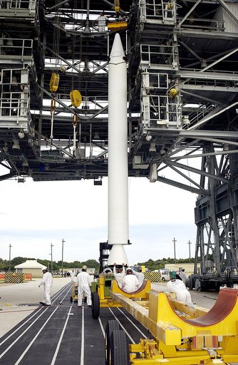 KENNEDY SPACE CENTER, FLA. - On Launch Complex 17-A, Cape Canaveral Air Force Station, workers complete raising a solid rocket booster to a vertical position.  It will be lifted up the launch tower and mated to the Delta rocket to launch Mars Exploration Rover 2. NASA’s twin Mars Exploration Rovers 