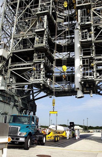 KENNEDY SPACE CENTER, FLA. -  While one solid rocket booster (SRB) is suspended in the launch tower on Launch Complex 17-A, Cape Canaveral Air Force Station, another is raised from its transporter for a similar lift.  They are two of nine SRBs that will be mated to the Delta rocket to launch Mars Ex