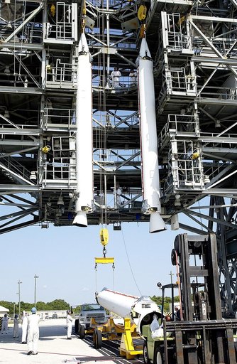 KENNEDY SPACE CENTER, FLA. - While two solid rocket boosters (SRBs) are suspended in the launch tower on Launch Complex 17-A, Cape Canaveral Air Force Station, another is being raised from its transporter for a similar lift.  They are three of nine SRBs that will be mated to the Delta rocket to laun