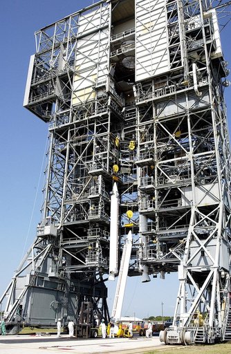 KENNEDY SPACE CENTER, FLA. - A third solid rocket booster (SRB) is lifted up the launch tower  on Launch Complex 17-A, Cape Canaveral Air Force Station.  They are three of nine SRBs that will be mated to the Delta rocket to launch Mars Exploration Rover 2. NASA’s twin Mars Exploration Rovers are des