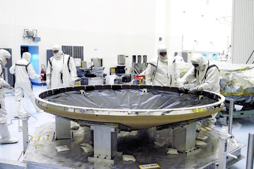 KENNEDY SPACE CENTER, FLA. - Workers in the Payload Hazardous Servicing Facility prepare the heat shield that will be attached to the backshell, surrounding Mars Exploration Rover 1 (MER-1).  NASA's twin Mars Exploration Rovers are designed to study the history of water on Mars. These robotic geolog