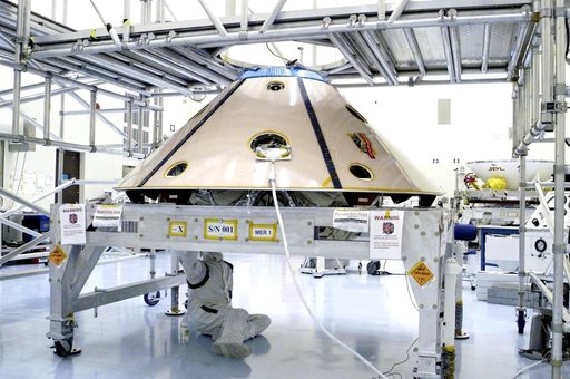 KENNEDY SPACE CENTER, FLA. - Workers in the Payload Hazardous Servicing Facility check the installation of the Mars Exploration Rover 1 (MER-1) inside the upper backshell.   The two components will be attached to the lower heat shield.  NASA's twin Mars Exploration Rovers are designed to study the h