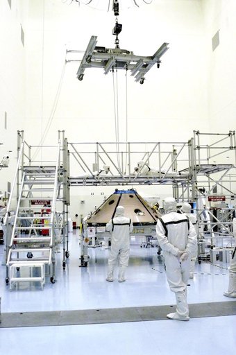 KENNEDY SPACE CENTER, FLA. -  An overhead crane is attached to the Mars Exploration Rover 1 (MER-1) inside the upper backshell.   The backshell will be moved and attached to the lower heat shield.  NASA's twin Mars Exploration Rovers are designed to study the history of water on Mars. These robotic 