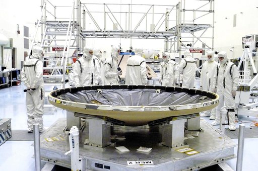 KENNEDY SPACE CENTER, FLA. - In the Payload Hazardous Servicing Facility, the heat shield (foreground) is ready to be mated with the upper backshell/ Mars Exploration Rover 1 (MER-1), in the background.  NASA's twin Mars Exploration Rovers are designed to study the history of water on Mars. These ro