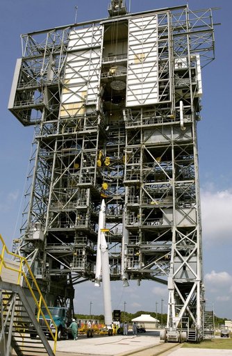 KENNEDY SPACE CENTER, FLA. - A third solid rocket booster (SRB) is lifted up the launch tower on Launch Complex 17-A, Cape Canaveral Air Force Station.  They are three of nine SRBs that will be mated to the Delta rocket to launch Mars Exploration Rover 2 (MER-2). NASA’s twin Mars Exploration Rovers 