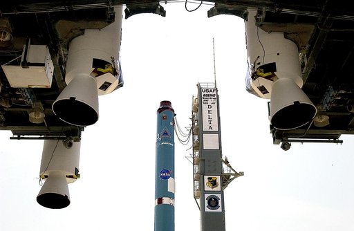 KENNEDY SPACE CENTER, FLA. -  In the foreground, three solid rocket boosters (SRBs) suspended in the launch tower flank the Delta II rocket (in the background) that will launch Mars Exploration Rover 2 (MER-2).  NASA’s twin Mars Exploration Rovers are designed to study the history of water on Mars. 