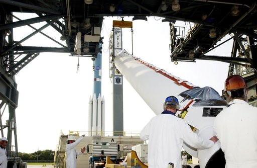 KENNEDY SPACE CENTER, FLA. -  Another solid rocket booster, in the foreground, is lifted off its transporter on Launch Complex 17-A, Cape Canaveral Air Force Station, for mating with the Delta II rocket in the background.  The SRB is one of nine that will help launch Mars Exploration Rover 2 (MER-2)