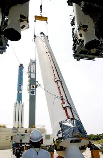 KENNEDY SPACE CENTER, FLA. -  A solid rocket booster (SRB) is lifted to vertical on Launch Complex 17-A, Cape Canaveral Air Force Station, joining two others in the launch tower.  They are three of nine SRBs that will help launch Mars Exploration Rover 2.  NASA’s twin Mars Exploration Rovers are des
