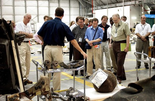 KENNEDY SPACE CENTER, FLA. -   Adm. Harold Gehman, far left, chairman of the Columbia Investigation Accident Board, looks at pieces of Columbia debris collected in the KSC RLV Hangar.  Other members of the board accompanied him as part of the ongoing investigation.  Recovery efforts as of May 5 incl