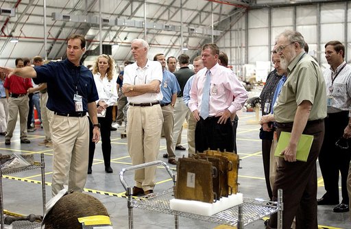 KENNEDY SPACE CENTER, FLA. -  Adm. Harold Gehman, center left, chairman of the Columbia Investigation Accident Board, and U.S. Representative Tom Feeney, center right, are shown pieces of Columbia debris collected in the KSC RLV Hangar.  Other members of the board accompanied Gehman as part of the o
