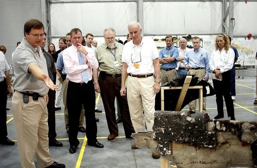 KENNEDY SPACE CENTER, FLA. - Adm. Harold Gehman, center left, chairman of the Columbia Investigation Accident Board, and U.S. Representative Tom Feeney, center right, are shown pieces of Columbia debris collected in the KSC RLV Hangar.  Other members of the board accompanied Gehman as part of the on